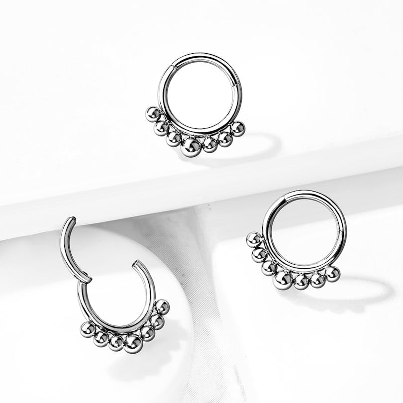 Argola de titânio com articulação e pequenas contas